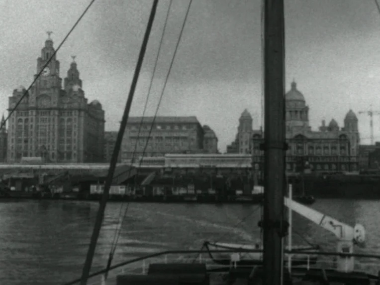 Madonna and Child (1980) movie still: establishing — The Liverpool Pier Head and Royal Liver Building stand prominently against an overcast sky. A…