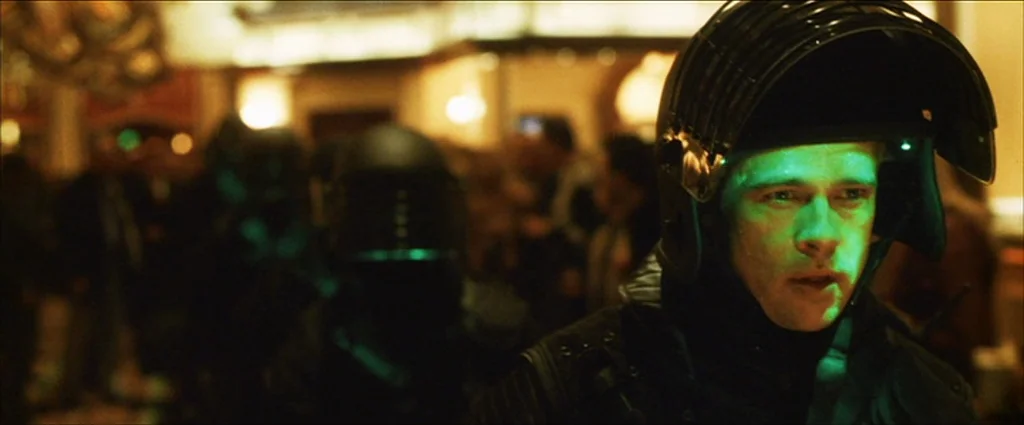 Ocean’s Eleven (2001) movie still: medium — A dimly lit room contains multiple figures in black tactical gear and helmets. A man in the foreground…