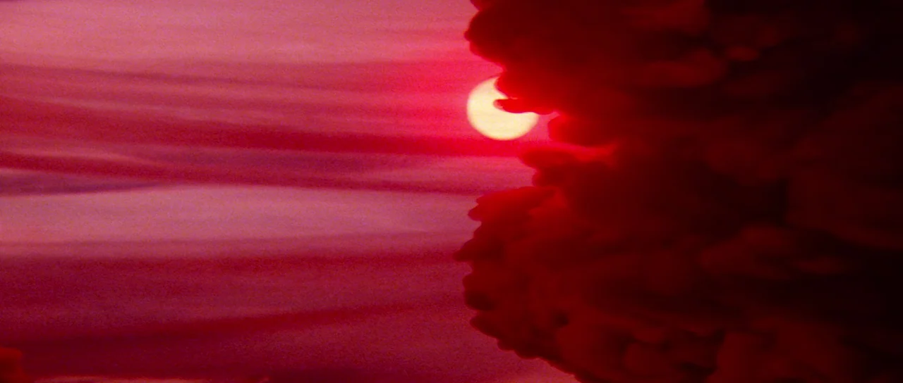 Flash Gordon (1980) movie still: establishing — A dark, heavy cloud formation obscures most of the sky on the right side. The sun peeks through the…