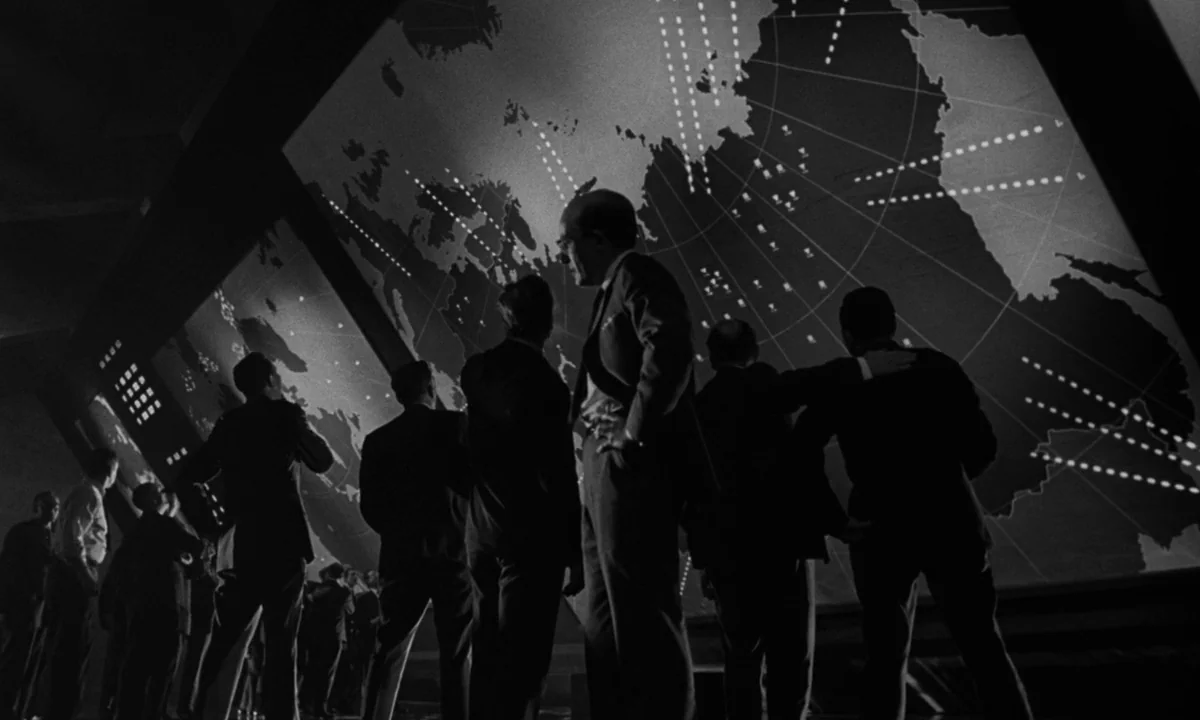 Dr. Strangelove or: How I Learned to Stop Worrying and Love the Bomb (1964) movie still: wide — A dark military command center features a massive…