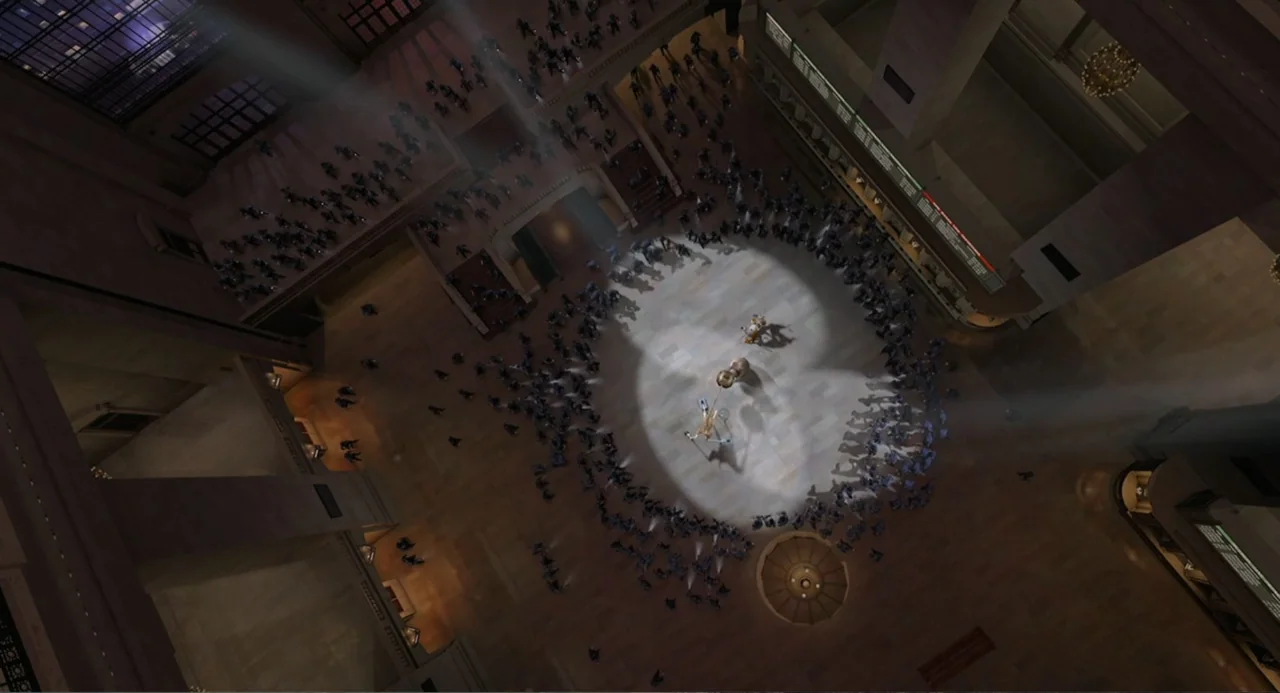 Madagascar (2005) movie still: establishing — A vast, high-ceilinged train terminal hall features stone floors and grand architectural elements. A…