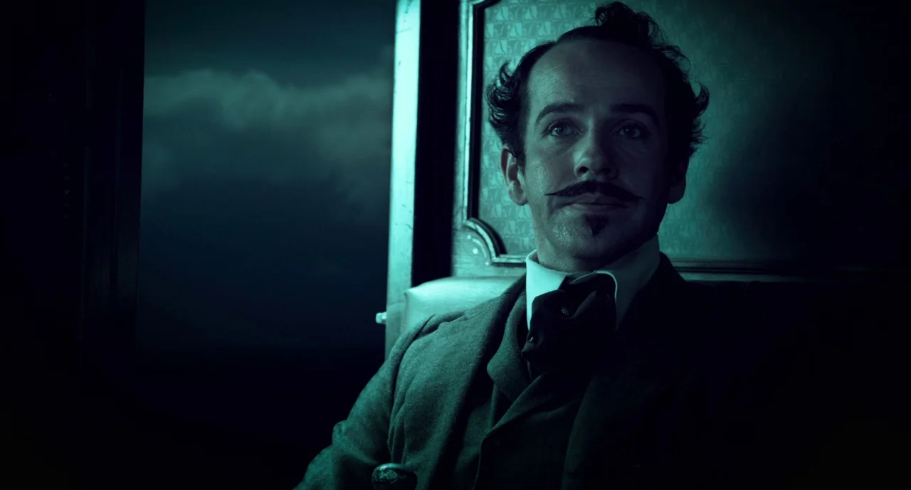 The Ballad of Buster Scruggs (2018) movie still: medium — A dark, period-accurate train compartment with upholstered leather seating and muted wall…
