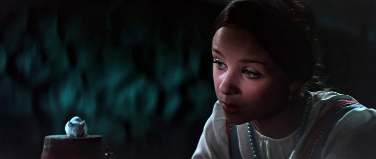Through Fire, Water and… Brass Pipes (1968) movie still: medium — A dimly lit room with textured dark walls and a stone-like surface behind the…