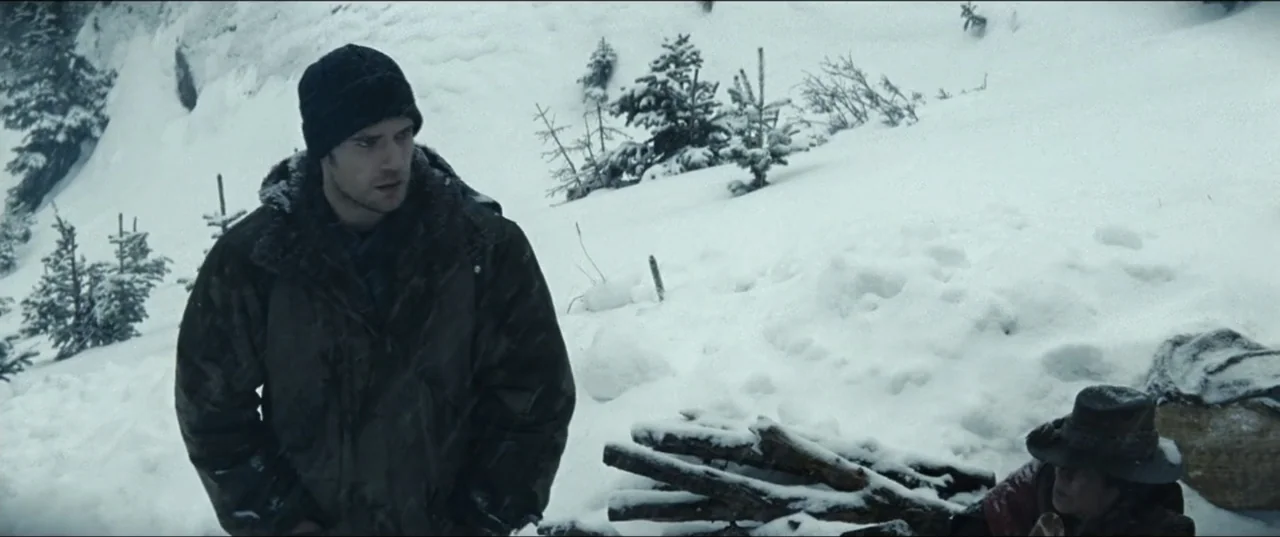 Batman v Superman: Dawn of Justice (2016) movie still: medium — A snowy mountain slope features a small camp with firewood scattered on the ground.…