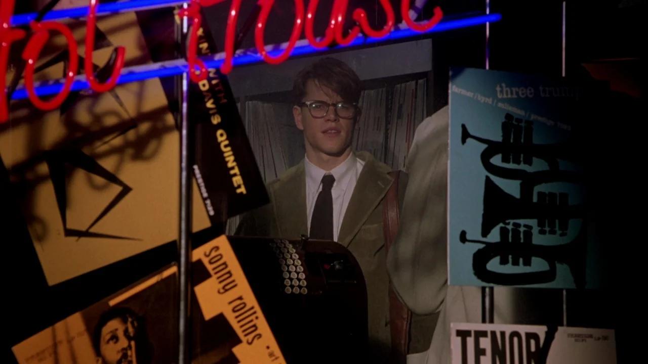 The Talented Mr. Ripley (1999) movie still: medium — A dark retail space filled with jazz records and music promotional materials. A young man…