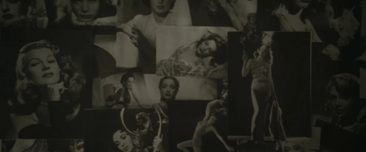 Starry Eyes (2014) movie still: wide — A vertical surface is densely covered with multiple overlapping black and white portraits. The photographs…