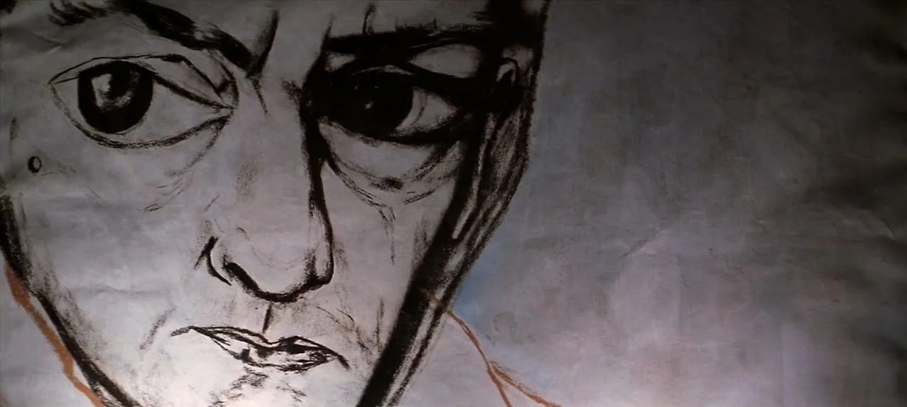Great Expectations (1998) movie still: closeup — A charcoal drawing of a man's face on a wrinkled sheet of paper. The paper occupies the frame…