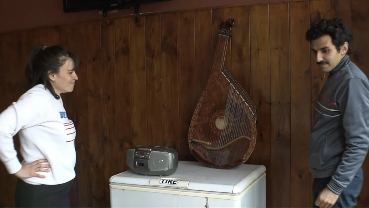 Smog in Your Heart (2022) movie still: medium — A basement room with dark wood-paneled walls and a white chest freezer.