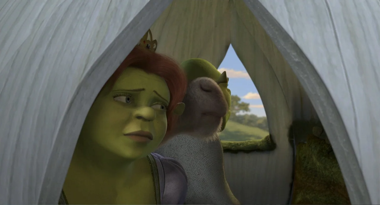 Shrek 2 (2004) movie still: medium — A light-colored fabric tent interior overlooks a green rolling hill landscape in daylight. A green ogre…