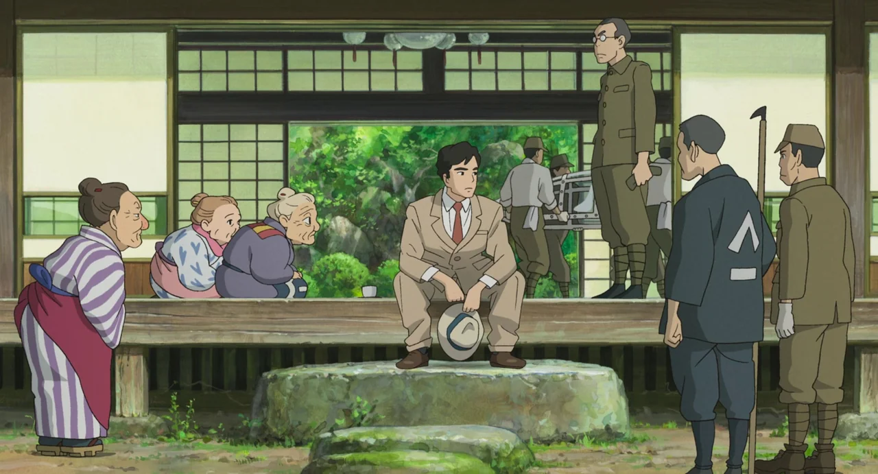 The Boy and The Heron (2023) movie still: wide — A traditional Japanese building with a wood veranda looks out onto a vibrant green garden. A man in…