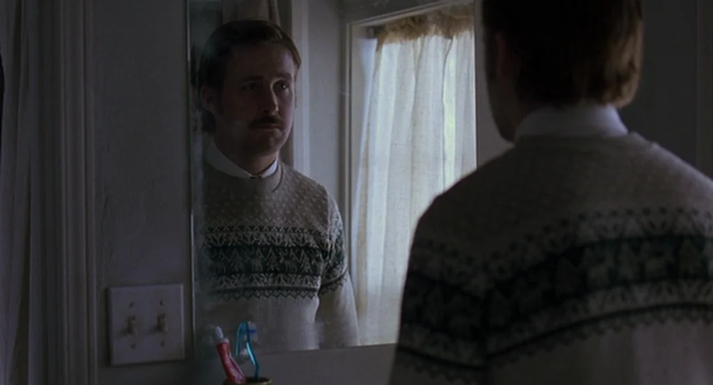 Lars And The Real Girl (2007) movie still: medium — A small residential bathroom features a wall-mounted mirror above a sink and counter. A man…