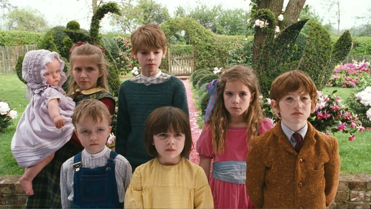 Nanny McPhee and the Big Bang (2010) movie still: medium — A group of children stands in front of swan-shaped topiary hedges. They are arranged in a…