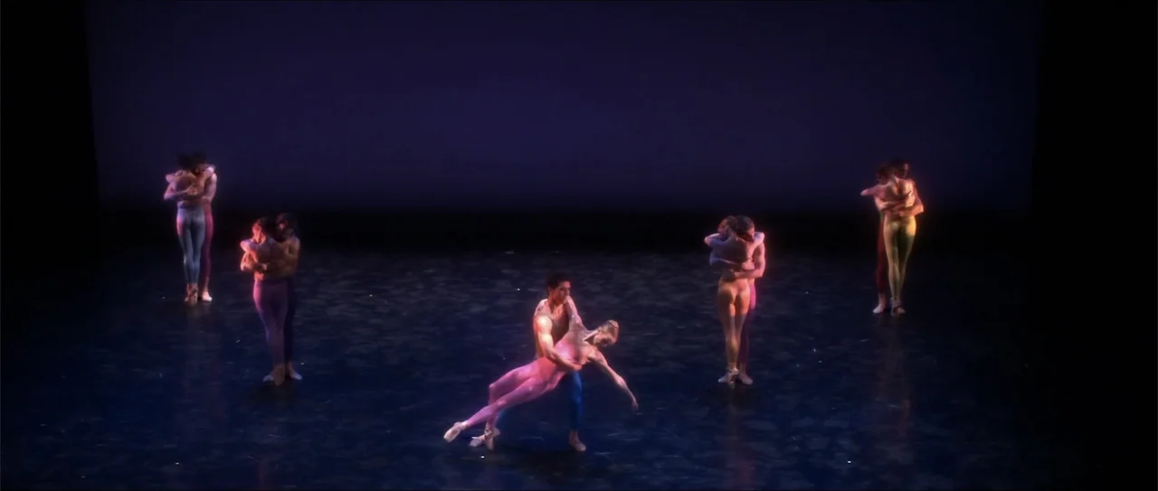 El acto (1989) movie still: wide — A spacious dark stage with a polished reflective floor features several pairs of dancers. Multiple couples in…