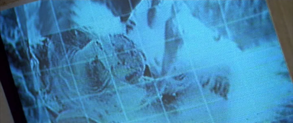 Alien 3 (1992) movie still: closeup — A close-up view of a cathode ray tube computer monitor showing a map. The screen displays a grid overlaying a…
