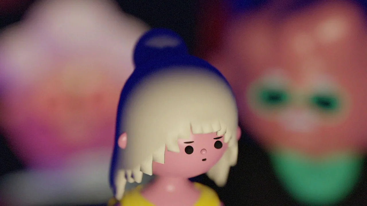 Boys Go To Jupiter (2024) movie still: closeup — A stylized plastic-like figurine stands in a dark environment with blurred colorful shapes behind.…