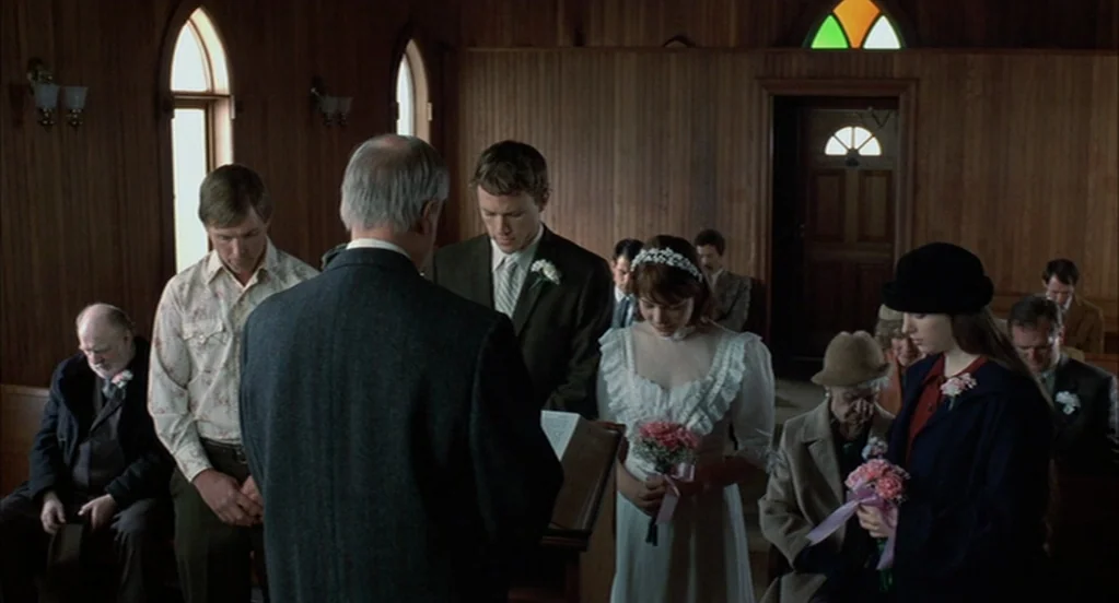 Brokeback Mountain (2005) movie still: medium — A wooden chapel interior features paneling and arched windows with a stained glass accent. A bride…