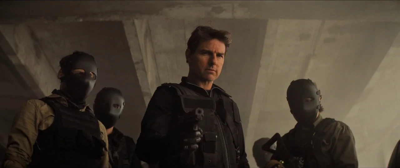 Mission: Impossible – Fallout (2018) movie still: medium — Concrete pillars form an overhead structure in a dimly lit, dusty underpass. Several…