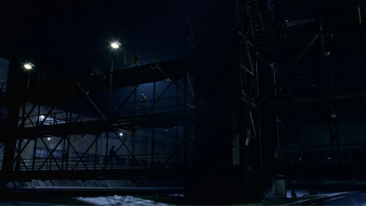 Underworld: Blood Wars (2016) movie still: wide — A dark industrial site at night features massive, multi-level metal scaffolding and rusted steel…