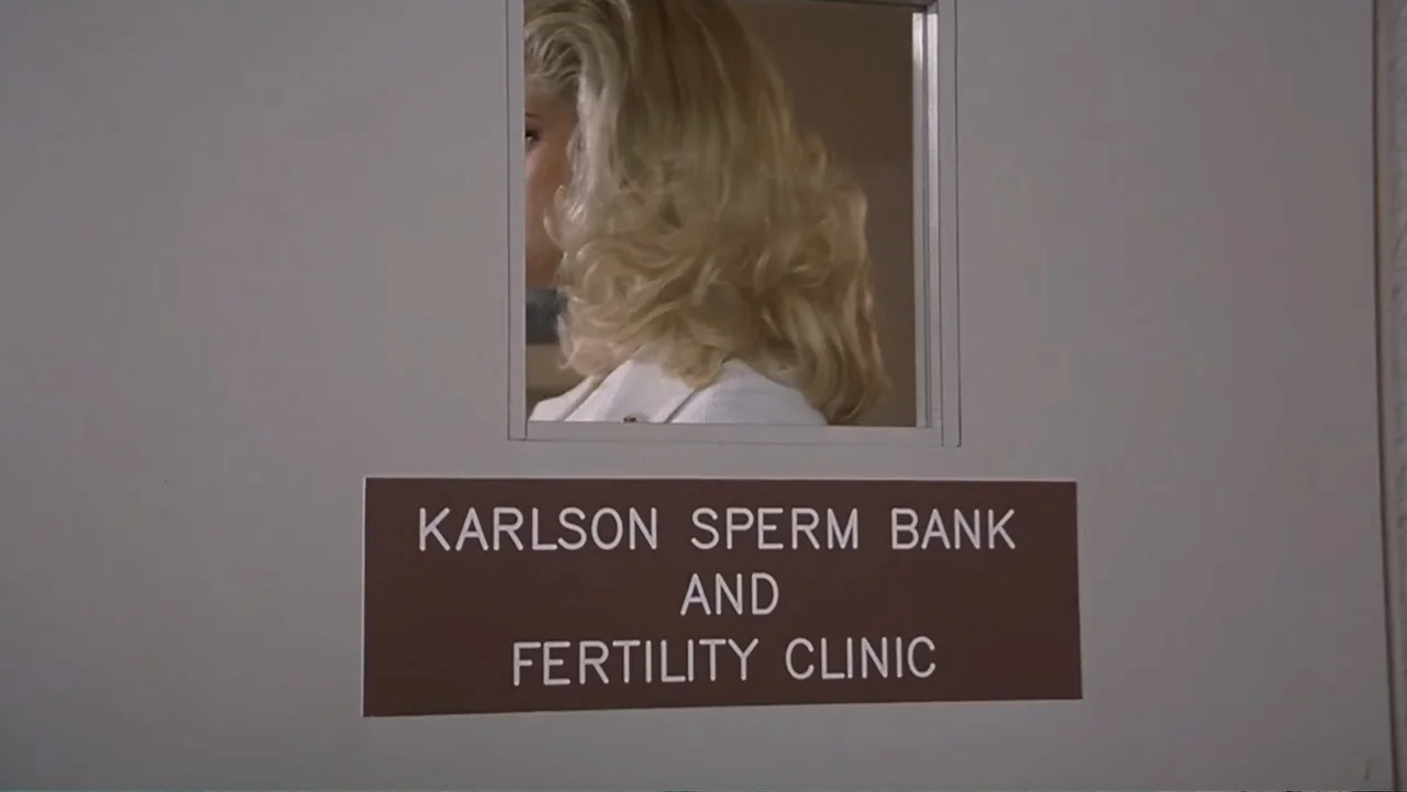 Naked Gun 33⅓: The Final Insult (1994) movie still: medium — A plain grey door features a brown sign that identifies a fertility clinic. A blonde…