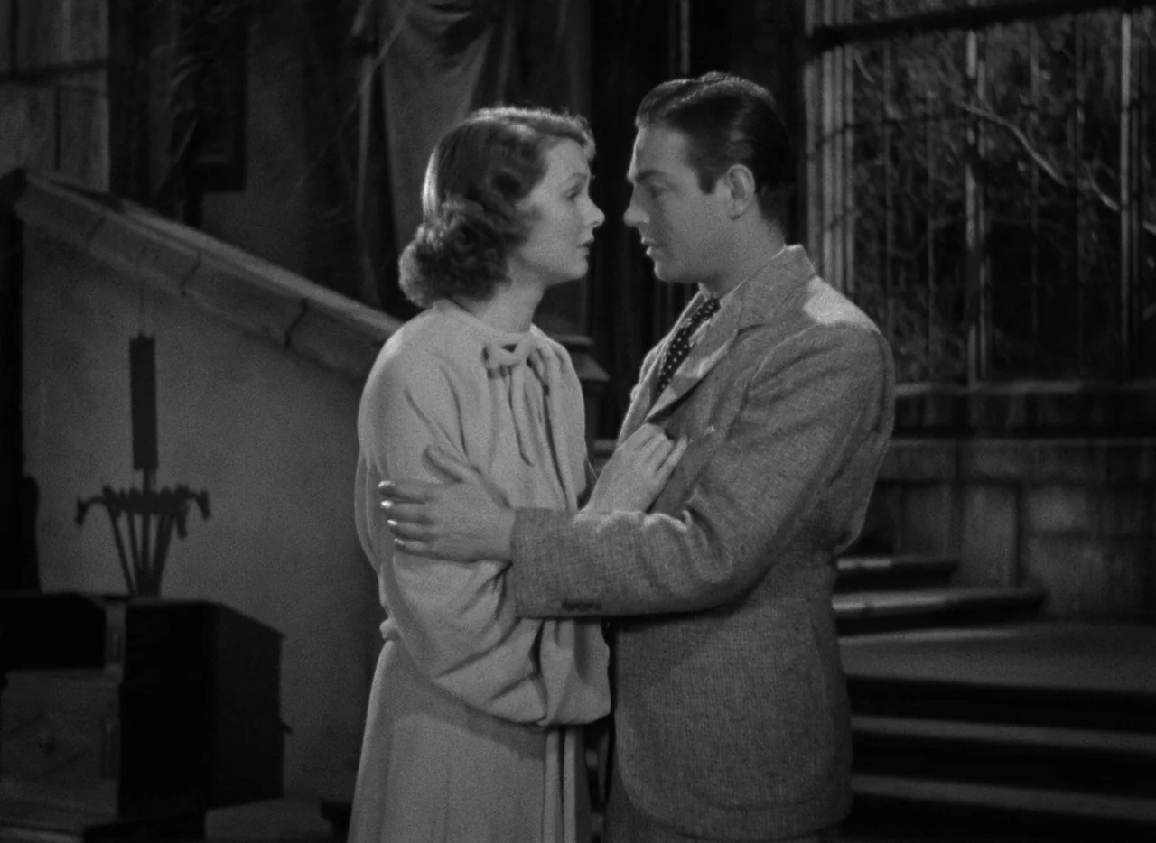 Mark of the Vampire (1935) movie still: medium — A man and woman stand on concrete steps outside a stone building at night. They stand in profile to…