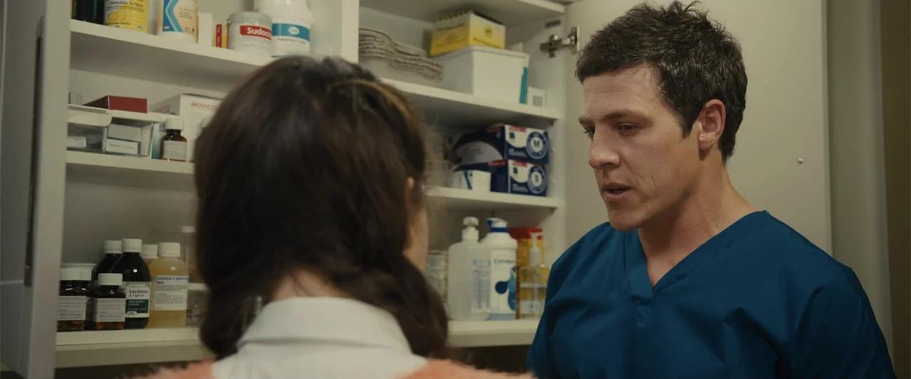 Me Before You (2016) movie still: medium — A well-stocked white medicine cabinet filled with various bottles and containers sits open. A male…