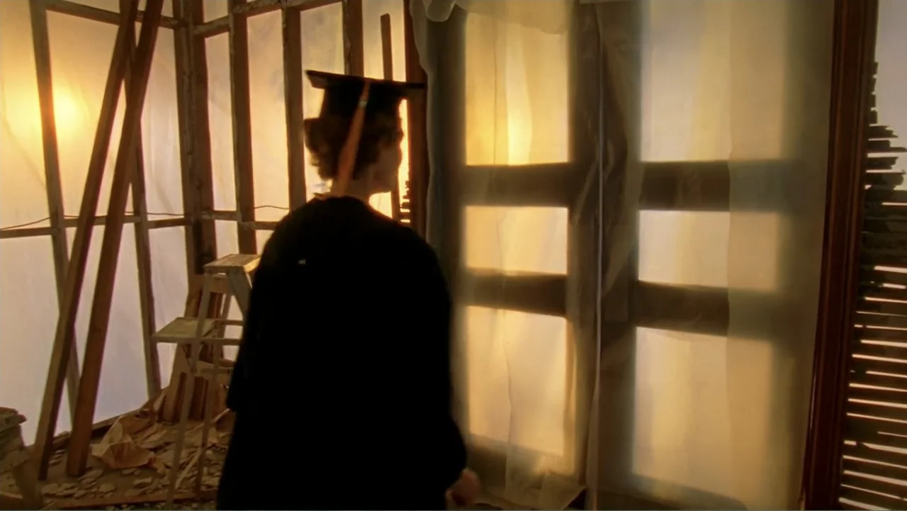 Temple Grandin (2010) movie still: medium — An interior space under renovation features exposed wooden framing and taped plastic window coverings. A…