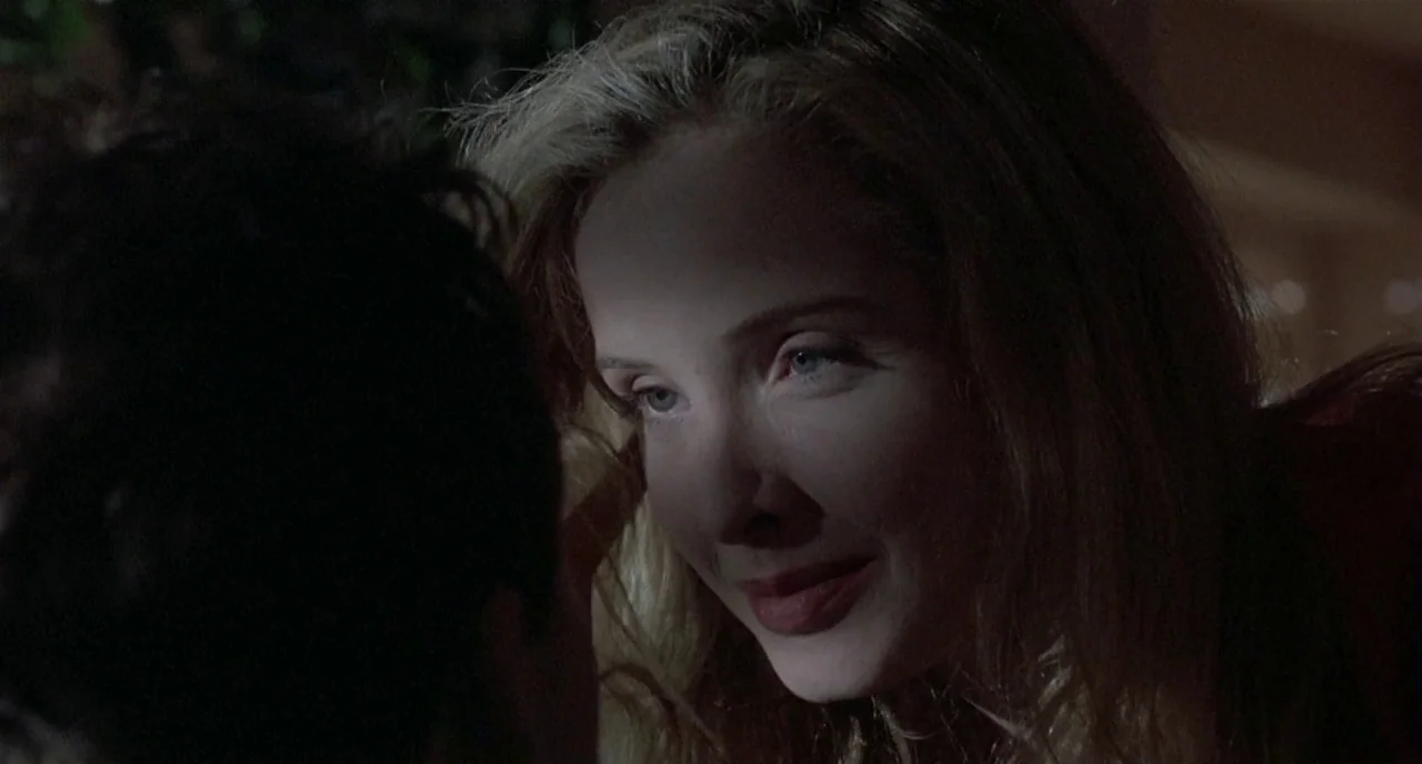 Three Colours: White (1994) movie still: closeup — A dimly lit indoor space with low-key illumination on the female subject. A woman leans in…