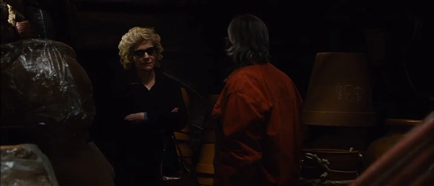 The Headless Woman (2008) movie still: medium — A dark, cluttered storage room is filled with stacked terracotta-colored ceramic pots and plastic. A…