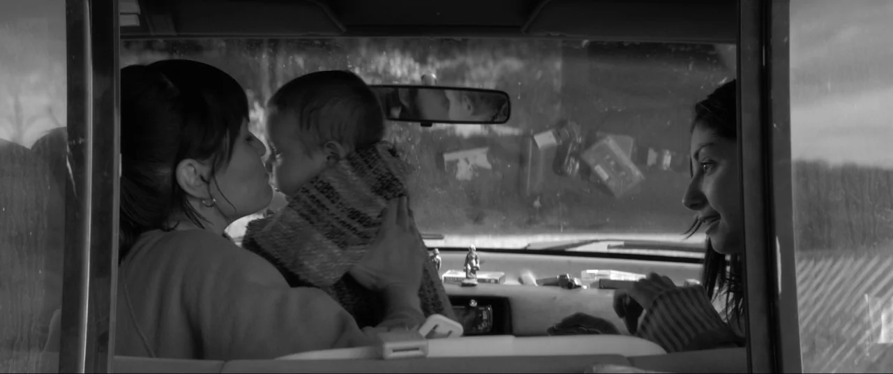 The Eyes of My Mother (2016) movie still: medium — The interior of a vehicle seen from the backseat looking toward the front console. Two women…