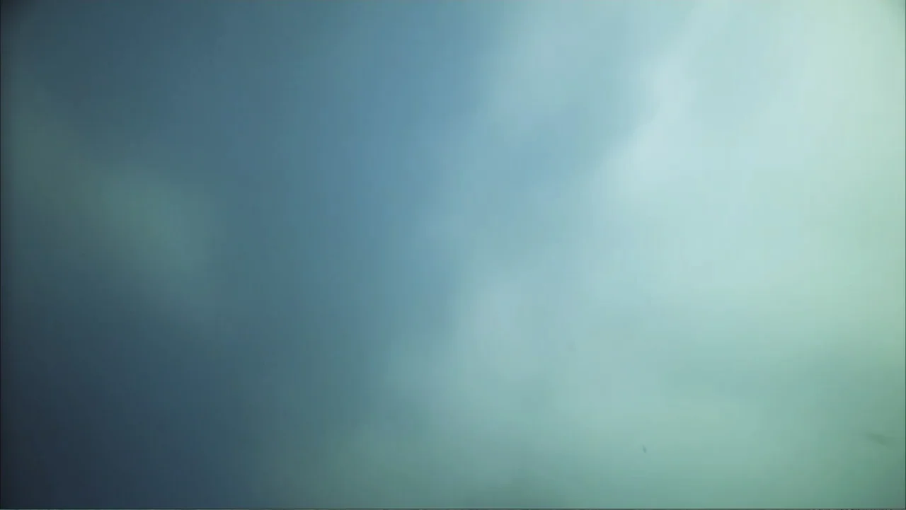 Deep Sea 3D (2006) movie still: establishing — An expanse of thick, overcast clouds fills the frame during the day. No terrestrial features or…