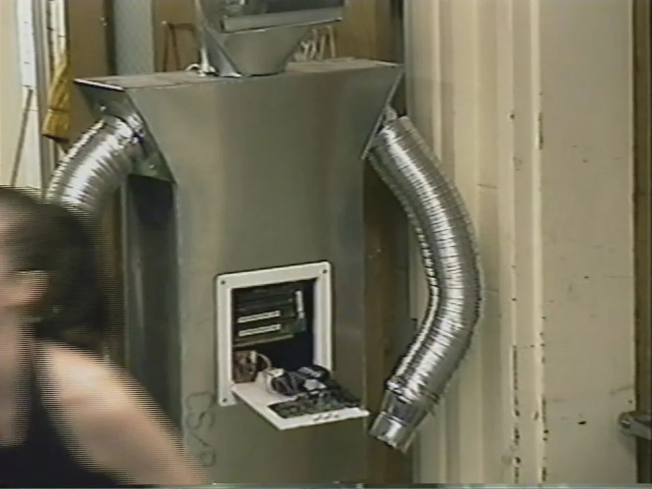 Dracula, Prisoner of Frankenstein (1972) movie still: medium — A homemade robot costume made of metallic sheets stands in a simple interior room.…