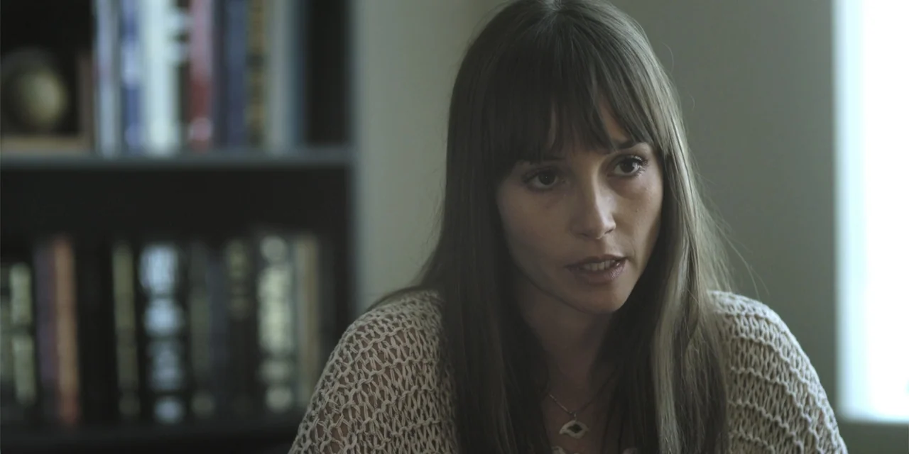 Stalked by My Doctor: A Sleepwalker's Nightmare (2019) movie still: closeup — An interior space with a bookshelf containing various books visible in…