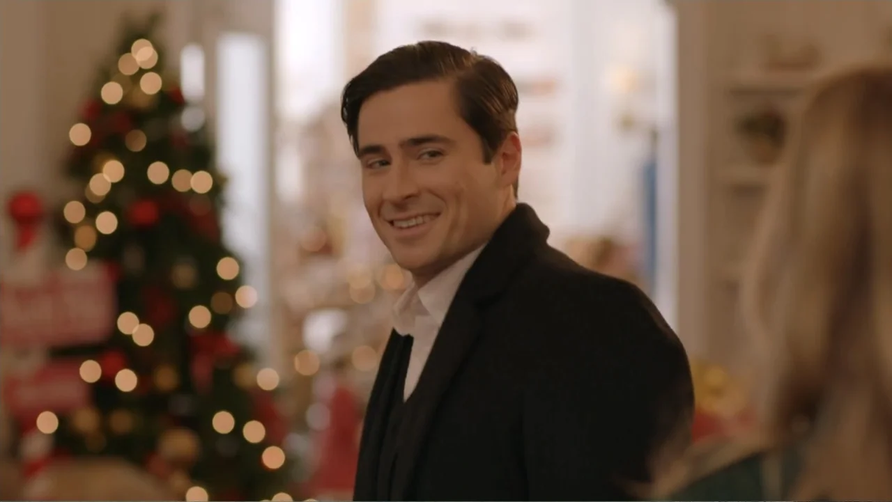 Loving Christmas (2022) movie still: medium — A well-lit interior space features a decorated Christmas tree with out-of-focus golden lights. A young…