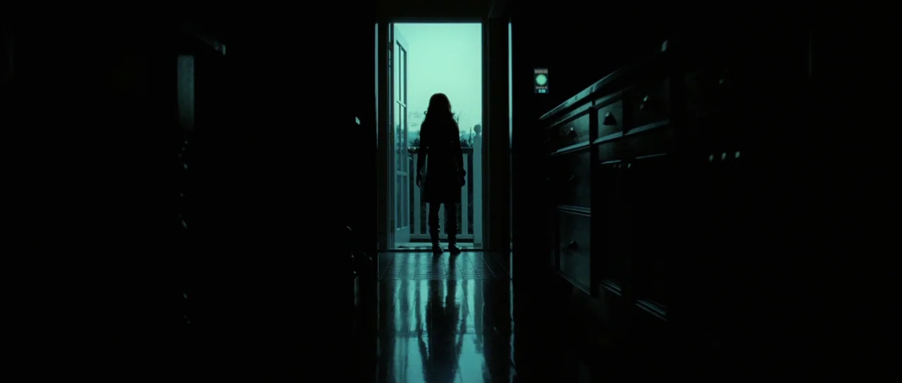 Daybreakers (2009) movie still: fullbody — A dark, narrow interior space leads to an open doorway bathed in daylight. A lone female figure stands in…