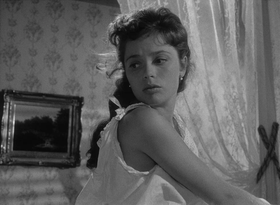Smiles Of A Summer Night (1955) movie still: closeup — A room with patterned wallpaper and a framed landscape painting on the wall. A young woman in…
