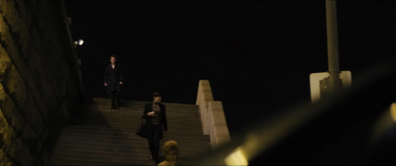 Jack Ryan: Shadow Recruit (2014) movie still: wide — An outdoor concrete staircase descends between a textured stone wall and a modern railing.…