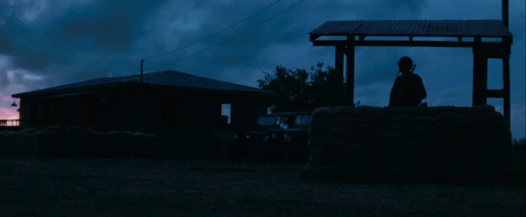 Che Part 1 (The Argentine) (2008) movie still: wide — A military outpost at dusk features a sandbag barrier and a simple roof structure. A lone…