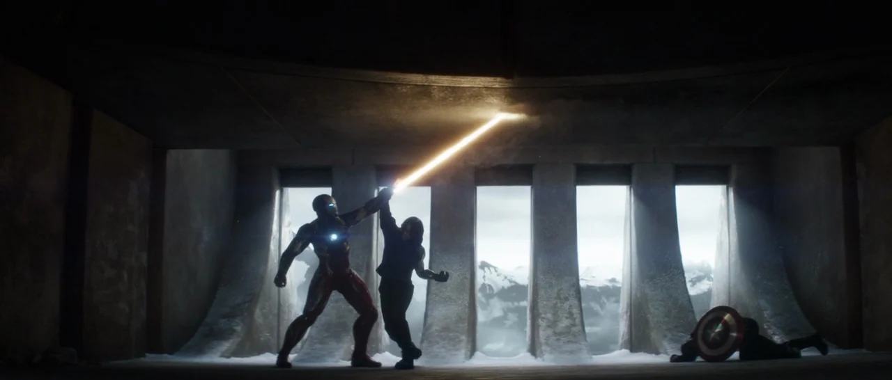 Captain America: Civil War (2016) movie still: wide — A dimly lit concrete bunker features vertical wall openings that look out onto mountains. Iron…
