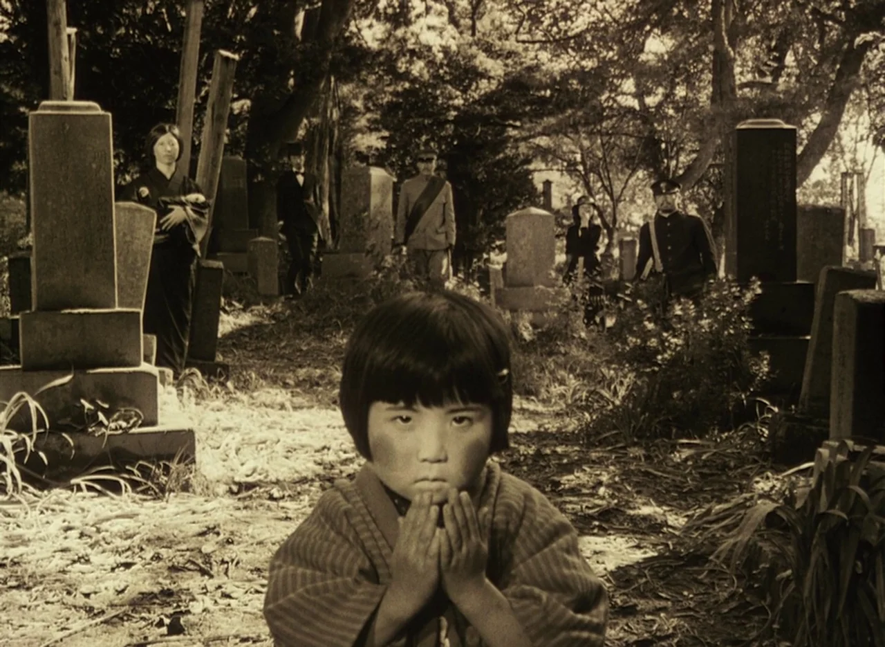 Pastoral To Die In The Country (1974) movie still: medium — An outdoor cemetery features numerous stone monuments surrounded by trees and overgrown…