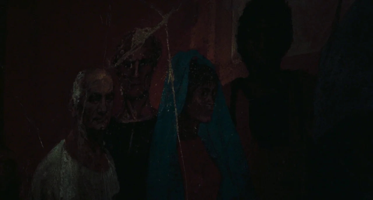 Roma (1972) movie still: medium — A mural depicting three individuals painted on a textured and cracked stone wall. The figures gaze forward in a…