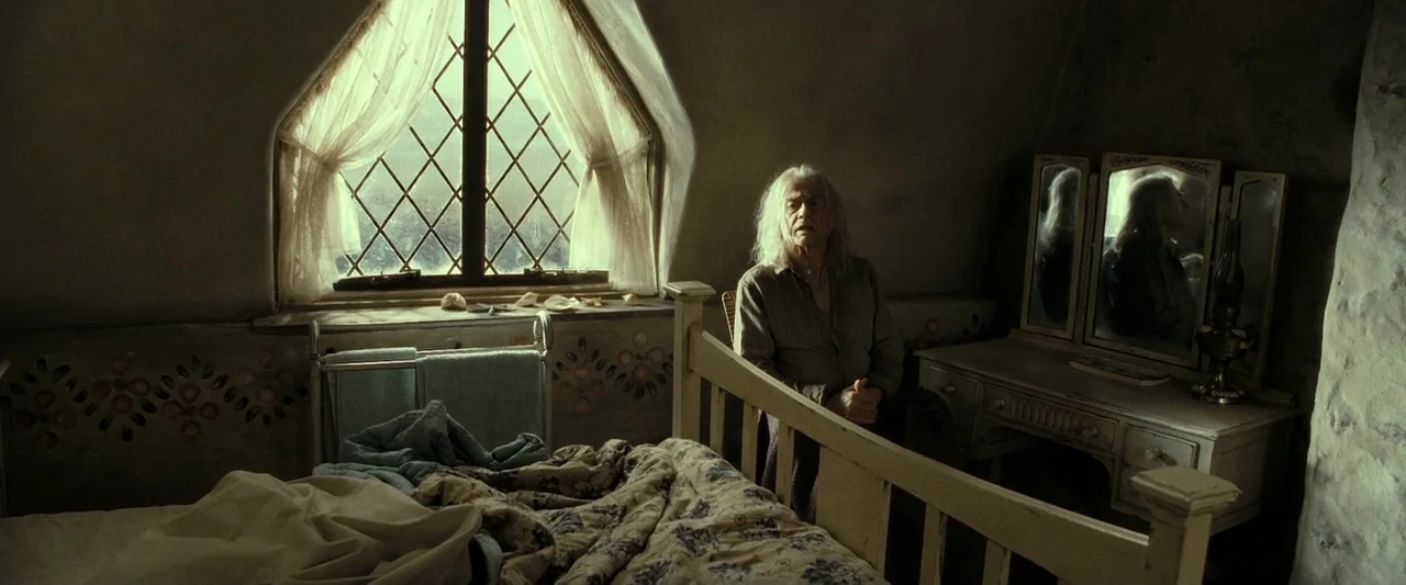 Harry Potter & The Deathly Hallows Part 2 (2011) movie still: medium — A rustic attic bedroom features floral wall patterns and a diamond-paned…