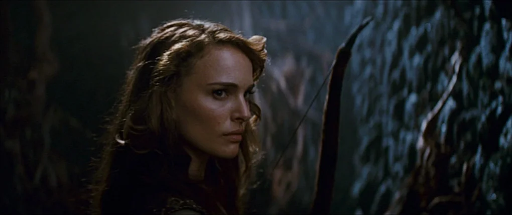 Your Highness (2011) movie still: medium — A dimly lit cavern features rough dark stone walls with twisted root-like textures. A woman with long…