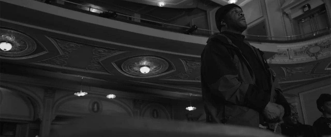 Maxine's Baby: The Tyler Perry Story (2023) movie still: medium — A spacious theater interior features ornate balcony railings and multiple ceiling…