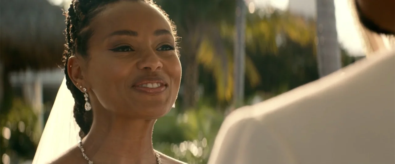 Bad Boys: Ride or Die (2024) movie still: closeup — An outdoor wedding venue with blurred tropical foliage in the background during golden hour. A…