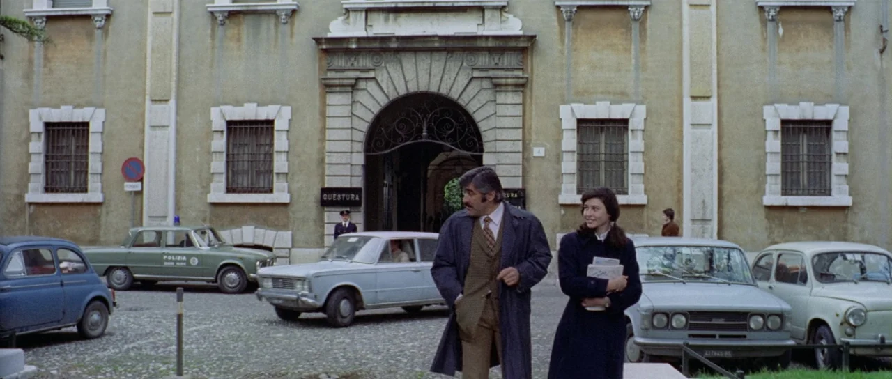What Have They Done To Your Daughters? (1974) movie still: wide — A historic stone building serves as a police headquarters with an arched stone…