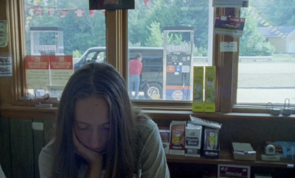 The Brown Bunny (2003) movie still: medium — The interior of a small rural convenience store features wooden walls and product shelves. A person…