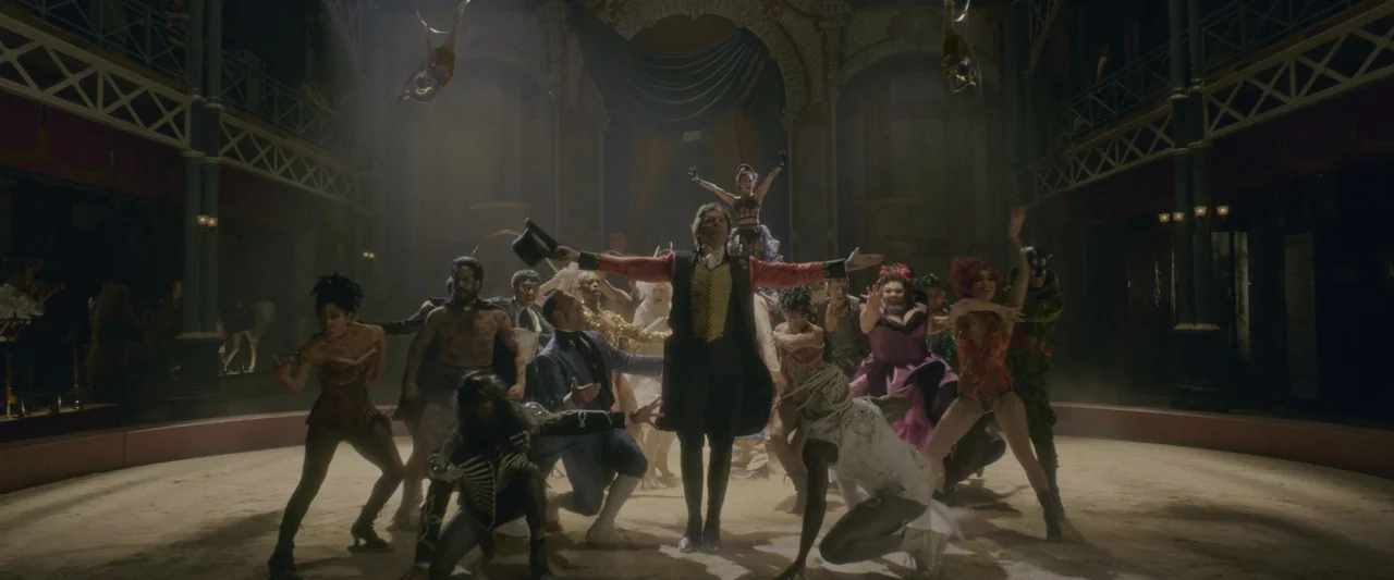 The Greatest Showman (2017) movie still: wide — A grand Victorian-style circus tent interior features a sandy performance floor. Numerous performers…