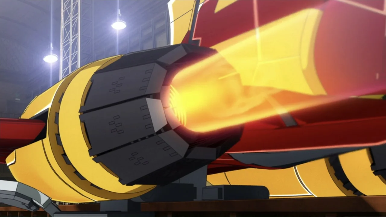 Mazinger Z: Infinity (2017) movie still: medium — A large yellow and red mechanical jet engine sits inside an industrial hangar space. The engine…