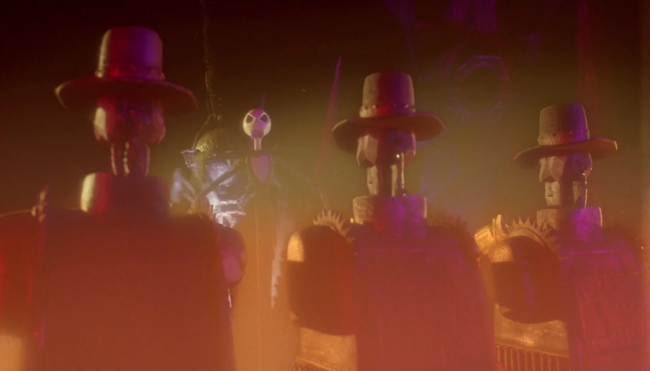 The Nightmare Before Christmas (1993) movie still: medium — A dimly lit room with multiple skeletal figures wearing wide-brimmed hats positioned in…