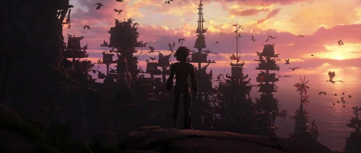 How to Train Your Dragon: The Hidden World (2019) movie still: wide — A clifftop village of layered wooden structures sits overlooking the sea…